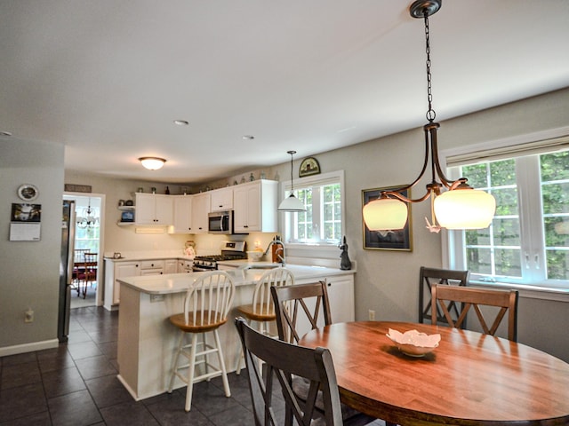 138 Page Rd, New London, NH 03257 - dining area with dark tile patterned flooring and baseboards