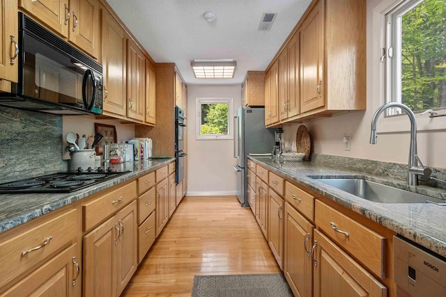 98 Marys Rd, Sunapee, NH 03782 - kitchen with black appliances, light wood-type flooring, backsplash, and brown cabinets