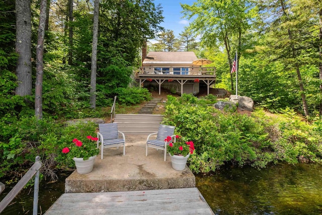 98 Marys Rd, Sunapee, NH 03782 - back of property with stairs, a deck with water view, a patio, and a chimney
