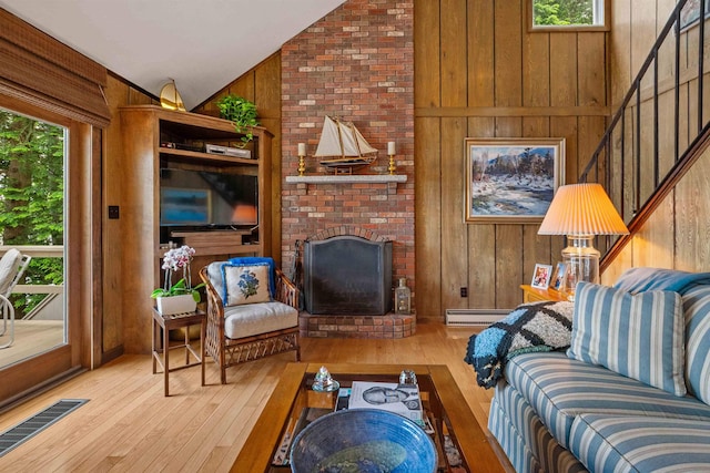 98 Marys Rd, Sunapee, NH 03782 - living area with a baseboard heating unit, lofted ceiling, hardwood / wood-style flooring, wooden walls, and a fireplace