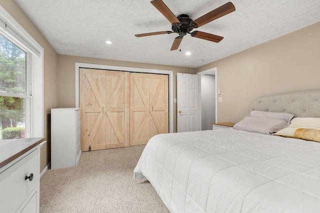 56 Durham Rd Unit 62, Dover, NH 03820 - bedroom with recessed lighting, a textured ceiling, light carpet, a ceiling fan, and a closet