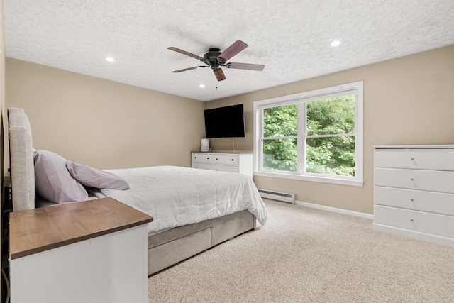 56 Durham Rd Unit 62, Dover, NH 03820 - carpeted bedroom featuring a baseboard heating unit, a textured ceiling, recessed lighting, and a ceiling fan