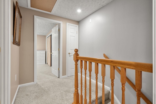56 Durham Rd Unit 62, Dover, NH 03820 - corridor featuring an upstairs landing, carpet flooring, and a textured ceiling