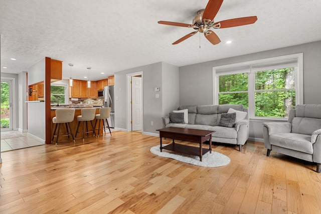 56 Durham Rd Unit 62, Dover, NH 03820 - living area featuring light wood-style flooring, a textured ceiling, ceiling fan, and recessed lighting