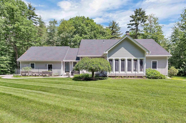 292 Forest Rd, Wolfeboro, NH 03894 - back of house with a lawn and a shingled roof
