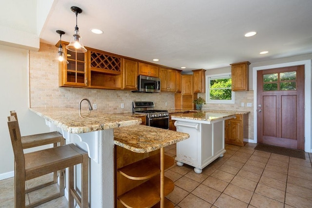 27 Wentworth Ter, Dover, NH 03820 - kitchen featuring open shelves, stainless steel appliances, a peninsula, a kitchen bar, and recessed lighting