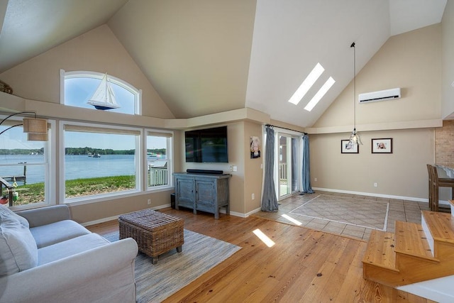 27 Wentworth Ter, Dover, NH 03820 - living room featuring high vaulted ceiling, healthy amount of natural light, hardwood / wood-style floors, and a wall unit AC