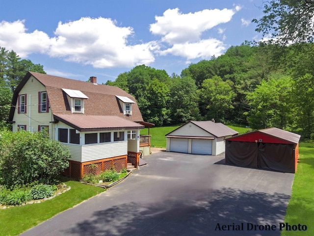 49 Bowker St, Claremont, NH 03743 - colonial inspired home featuring a gambrel roof, an outdoor structure, a garage, a chimney, and a shingled roof