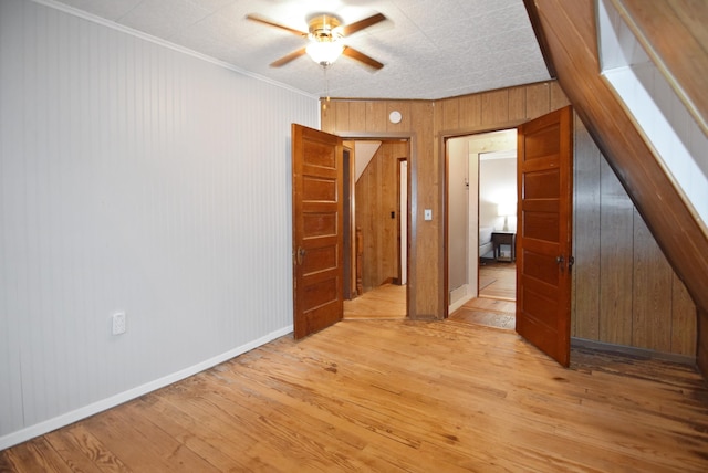 49 Bowker St, Claremont, NH 03743 - spare room featuring ceiling fan, wood-type flooring, wood walls, and ornamental molding