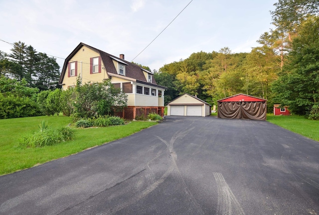 49 Bowker St, Claremont, NH 03743 - view of front facade featuring a gambrel roof, an outbuilding, a detached garage, and a front yard