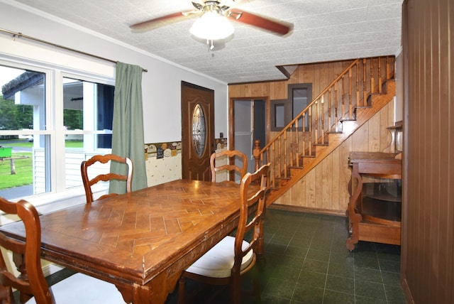 49 Bowker St, Claremont, NH 03743 - dining room with wooden walls, stairs, ceiling fan, and crown molding