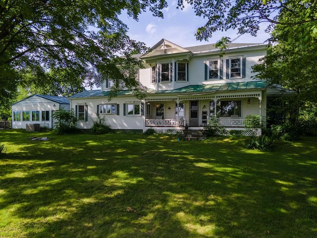 50 Lane Ridge Rd, Claremont, NH 03743 - victorian house featuring covered porch, a front yard, a metal roof, and a standing seam roof