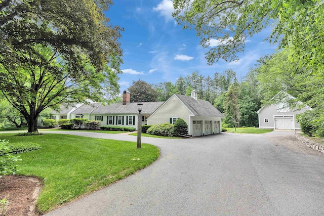 16 Storybrook Ln, Amherst, NH 03031 - view of front of home with a front yard, a chimney, a garage, and driveway