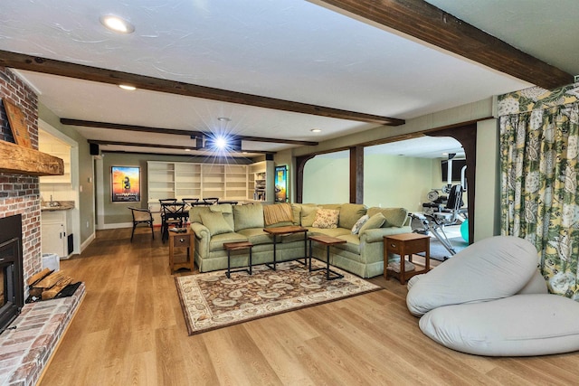 16 Storybrook Ln, Amherst, NH 03031 - living room featuring beamed ceiling, wood finished floors, a brick fireplace, recessed lighting, and arched walkways