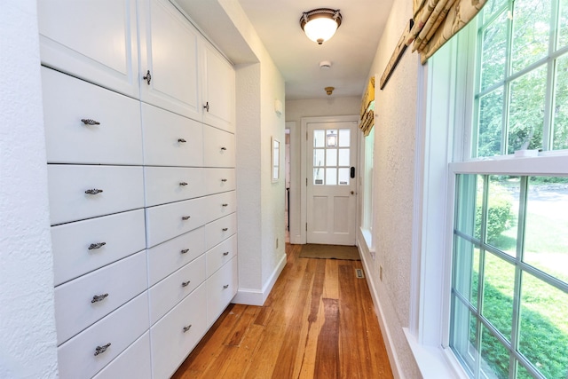 16 Storybrook Ln, Amherst, NH 03031 - hallway with light wood-style flooring and a textured wall
