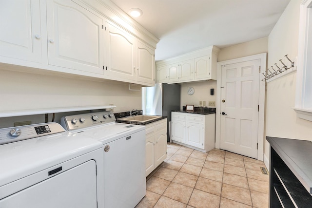 16 Storybrook Ln, Amherst, NH 03031 - washroom with washer and dryer, cabinet space, and light tile patterned floors