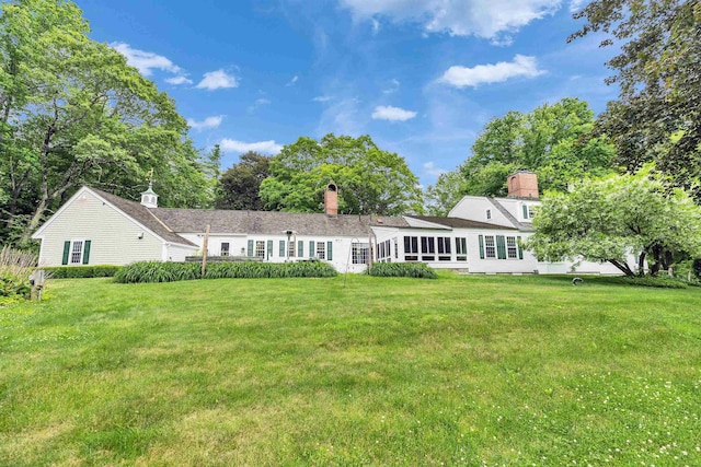 16 Storybrook Ln, Amherst, NH 03031 - back of house featuring a yard and a chimney