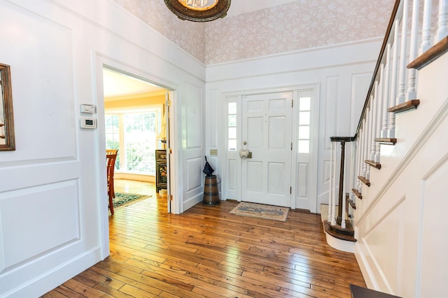 16 Storybrook Ln, Amherst, NH 03031 - entrance foyer featuring a decorative wall, hardwood / wood-style floors, stairway, and wallpapered walls