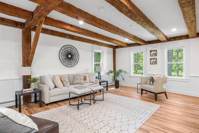 71 Plummer Hill Rd, Belmont, NH 03220 - living area with beamed ceiling, light wood finished floors, and a wainscoted wall