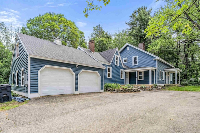 71 Plummer Hill Rd, Belmont, NH 03220 - view of front of home with a chimney, roof with shingles, driveway, and an attached garage