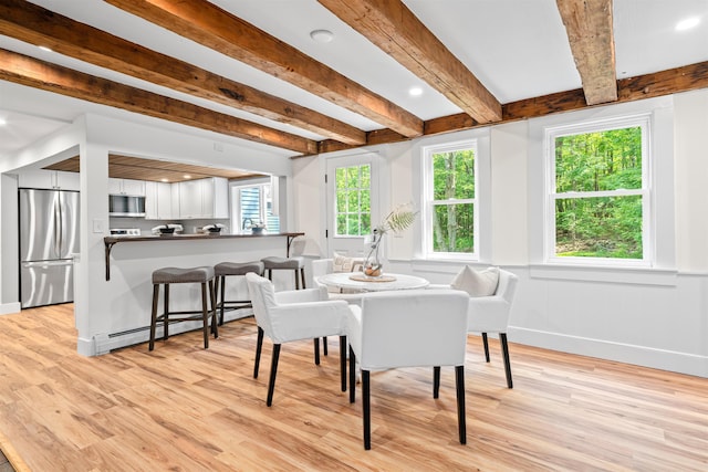 71 Plummer Hill Rd, Belmont, NH 03220 - dining space featuring a baseboard heating unit, light wood-style flooring, and beamed ceiling