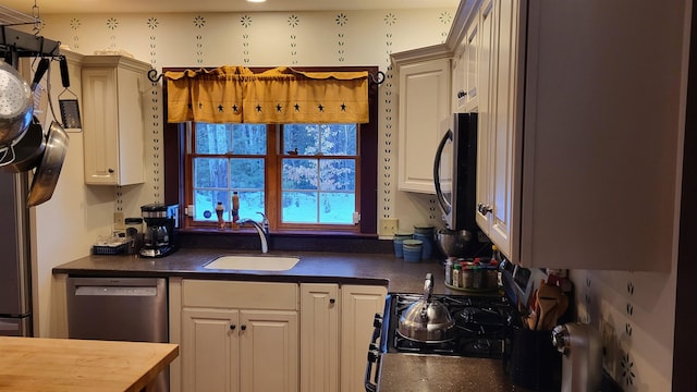 987 Dunbar Hill Rd, Grantham, NH 03753 - kitchen with stainless steel appliances, dark countertops, and white cabinets