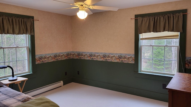 987 Dunbar Hill Rd, Grantham, NH 03753 - carpeted bedroom featuring a baseboard heating unit, multiple windows, wallpapered walls, and a ceiling fan