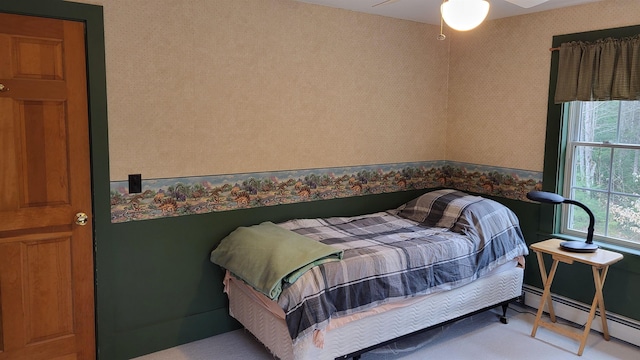 987 Dunbar Hill Rd, Grantham, NH 03753 - bedroom with baseboard heating, multiple windows, wallpapered walls, and ceiling fan