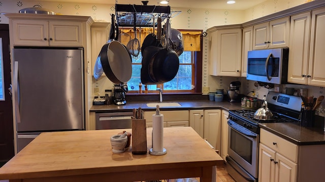 987 Dunbar Hill Rd, Grantham, NH 03753 - kitchen featuring appliances with stainless steel finishes, wood counters, and cream cabinetry