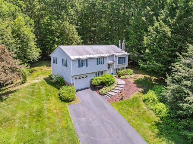 5 Cowin Rd, Merrimack, NH 03054 - raised ranch featuring asphalt driveway, a garage, a front lawn, and a wooded view