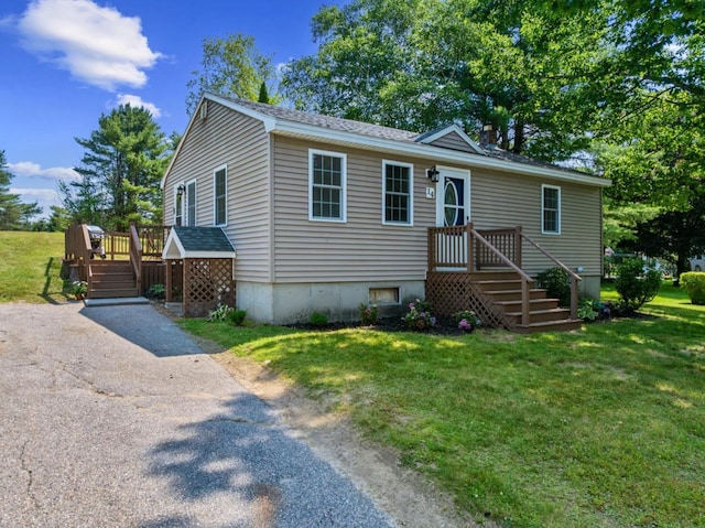 14 Anagance Ln, Wolfeboro, NH 03894 - view of front of property featuring a front yard, a wooden deck, and roof with shingles