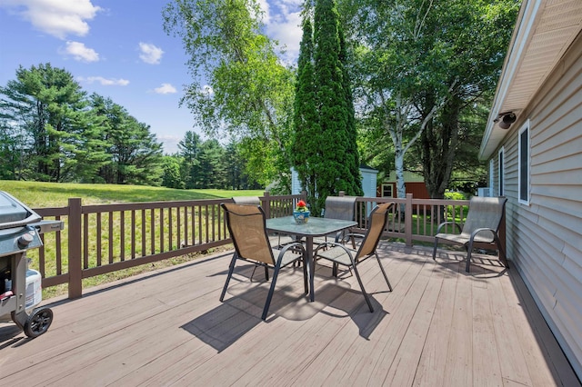 14 Anagance Ln, Wolfeboro, NH 03894 - deck with outdoor dining space, grilling area, an outdoor structure, a lawn, and view of scattered trees