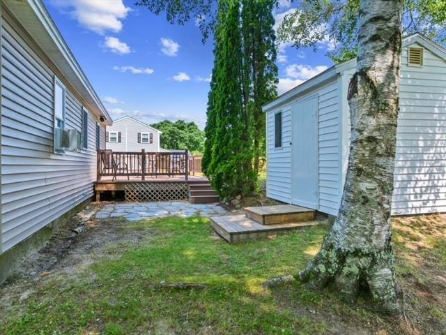 14 Anagance Ln, Wolfeboro, NH 03894 - view of green lawn with a deck and cooling unit