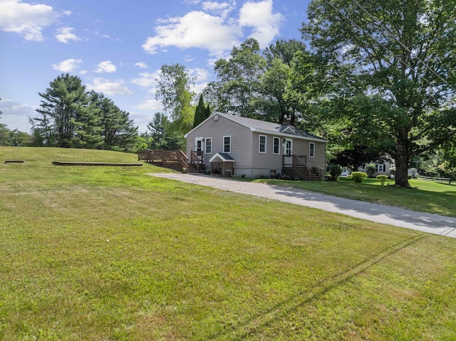14 Anagance Ln, Wolfeboro, NH 03894 - view of front of home featuring a deck and a front lawn