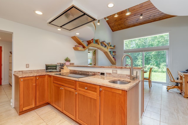 123 Stephen Dr, Goffstown, NH 03045 - kitchen featuring black electric stovetop, a peninsula, lofted ceiling, light stone countertops, and recessed lighting