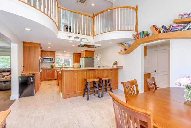123 Stephen Dr, Goffstown, NH 03045 - dining room with healthy amount of natural light, a high ceiling, and recessed lighting