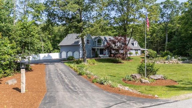 123 Stephen Dr, Goffstown, NH 03045 - cape cod-style house with driveway, a front lawn, and a garage