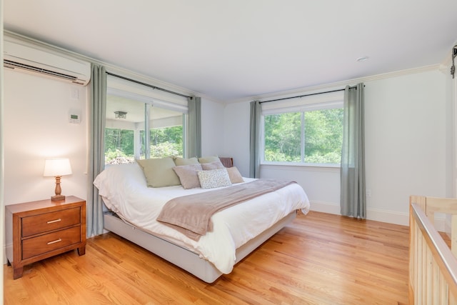 123 Stephen Dr, Goffstown, NH 03045 - bedroom with a wall mounted air conditioner, light wood-style flooring, and crown molding