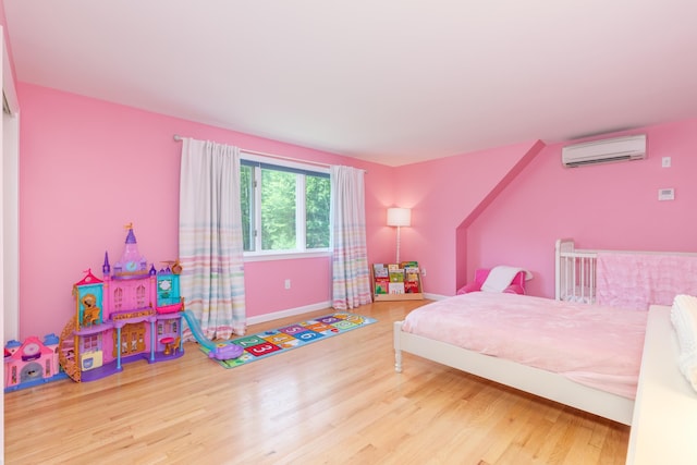 123 Stephen Dr, Goffstown, NH 03045 - bedroom with a wall mounted air conditioner and wood finished floors
