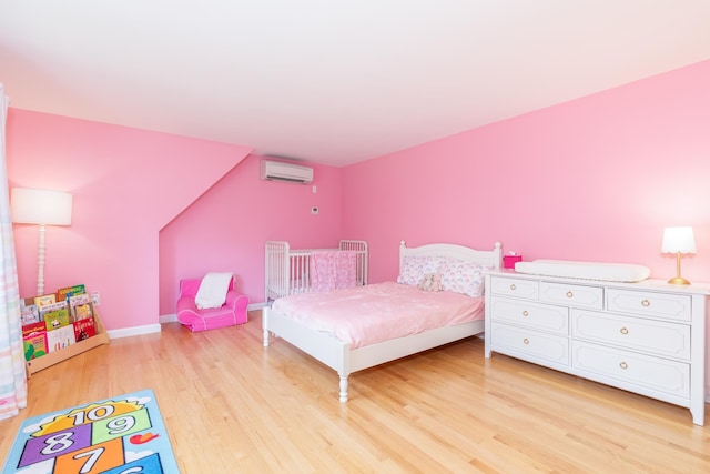 123 Stephen Dr, Goffstown, NH 03045 - bedroom featuring an AC wall unit and light wood-type flooring