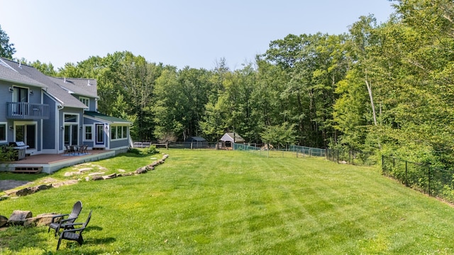 123 Stephen Dr, Goffstown, NH 03045 - fenced backyard with a deck, a balcony, and a forest view