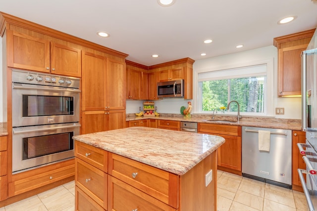 123 Stephen Dr, Goffstown, NH 03045 - kitchen featuring stainless steel appliances, recessed lighting, light stone counters, a kitchen island, and light tile patterned flooring