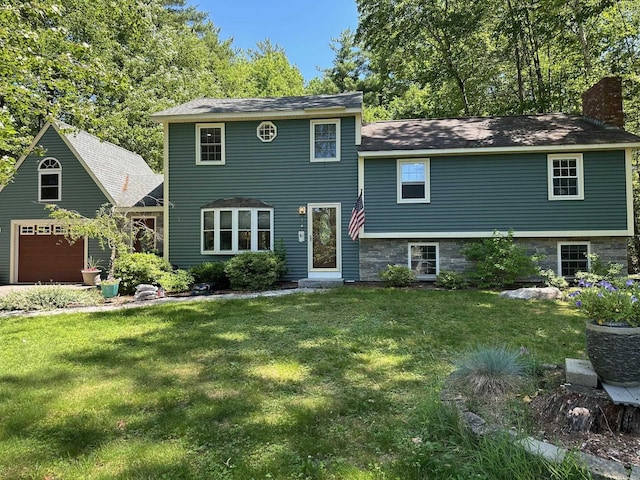 22 Mason Rd, Merrimack, NH 03054 - split level home with a chimney, a front yard, and a garage
