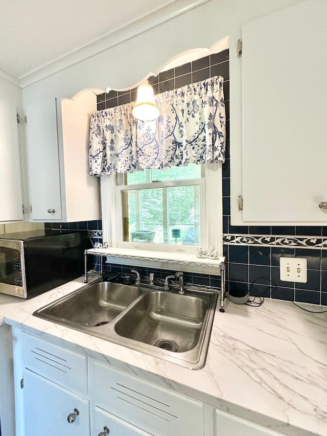 22 Mason Rd, Merrimack, NH 03054 - kitchen with stainless steel microwave, crown molding, white cabinets, and light stone counters
