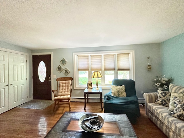 22 Mason Rd, Merrimack, NH 03054 - living room featuring hardwood / wood-style flooring, baseboard heating, and a textured ceiling