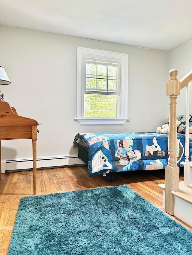 22 Mason Rd, Merrimack, NH 03054 - bedroom featuring a baseboard heating unit and wood finished floors