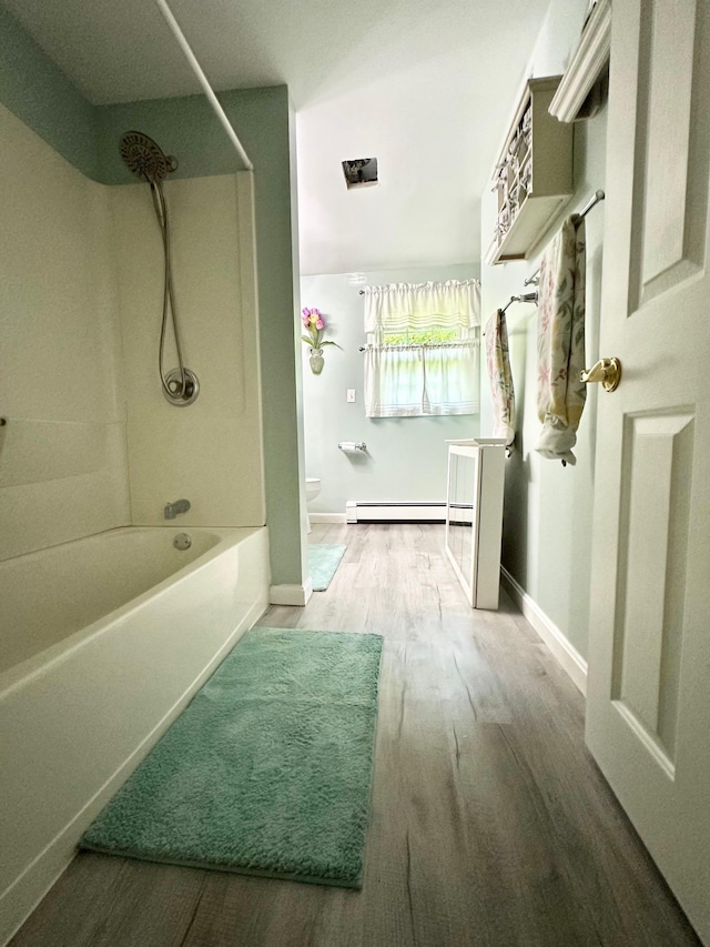 22 Mason Rd, Merrimack, NH 03054 - bathroom with shower / washtub combination, a baseboard radiator, and wood finished floors