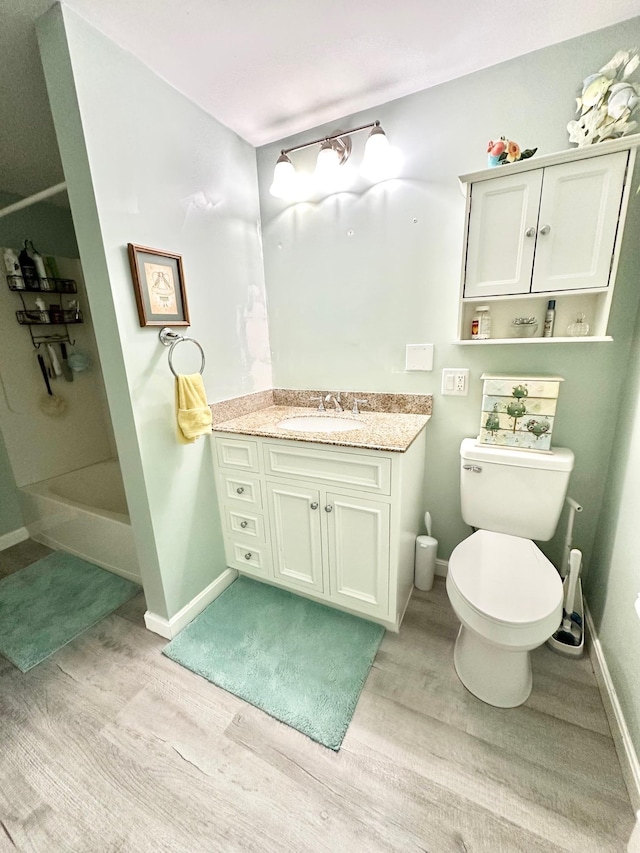 22 Mason Rd, Merrimack, NH 03054 - bathroom featuring wood finished floors, vanity, and a tub