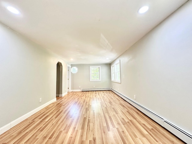 22 Mason Rd, Merrimack, NH 03054 - spare room with arched walkways, recessed lighting, a baseboard radiator, light wood finished floors, and baseboard heating