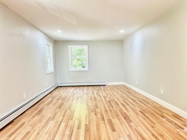 22 Mason Rd, Merrimack, NH 03054 - empty room with a baseboard heating unit, light wood-style floors, and recessed lighting